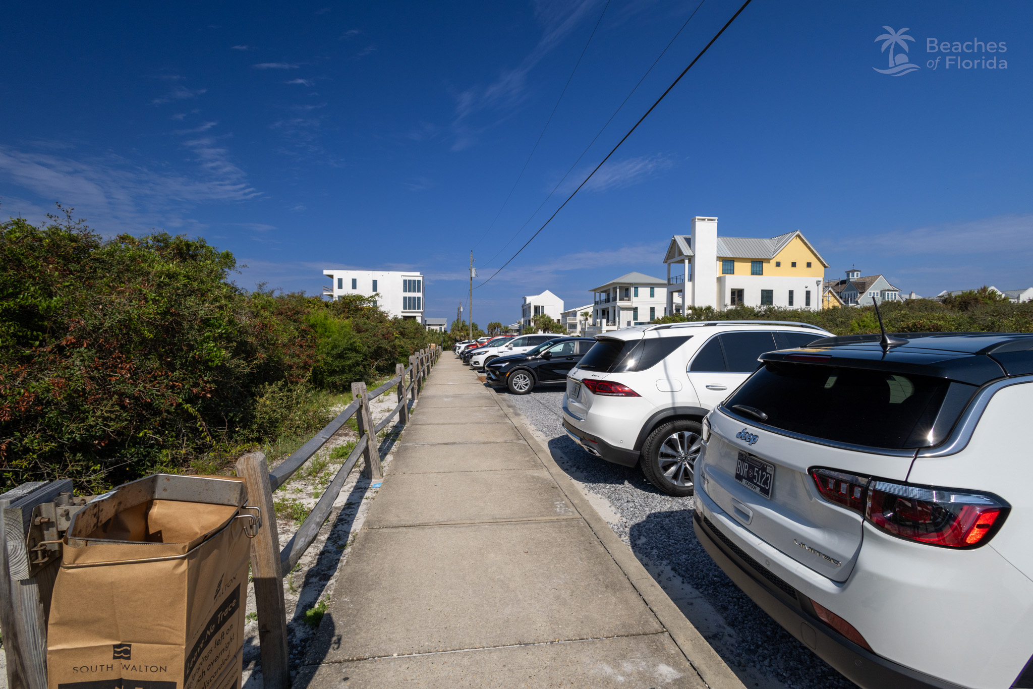 Free parking area and sidewalk at Inlet Beach with beach homes in the background